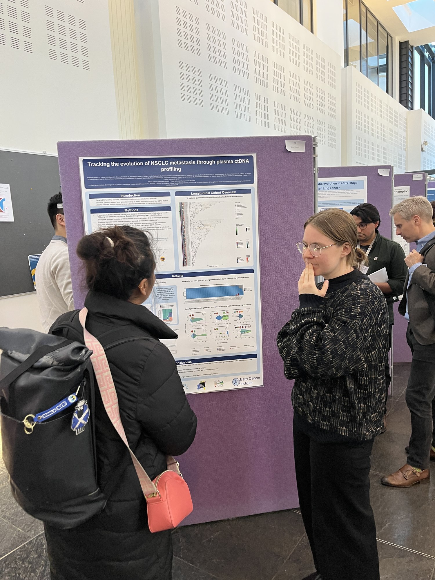 Katie Honan talks through her poster with a fellow attendee, Cambridge Lung Symposium 2025